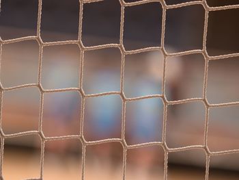 Tournament view through the protective net of futsal match. visitor view from vip chair.