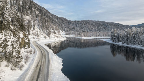 Scenic view of lake and mountains against sky