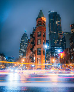 Long exposure of vehicles on road in city at night