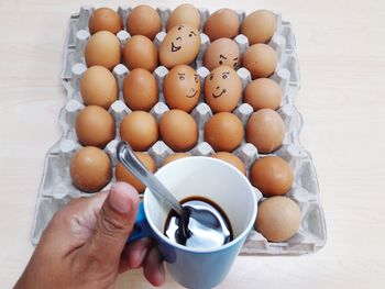 High angle view of hand holding coffee