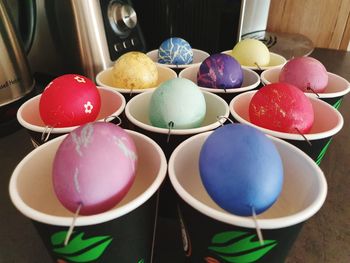 High angle view of multi colored eggs on table