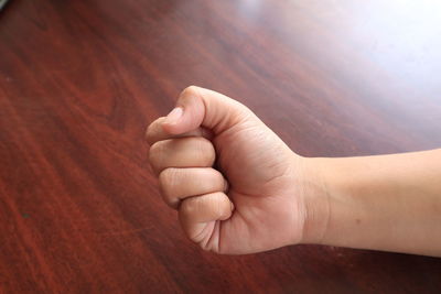 Close-up of person hand holding wood