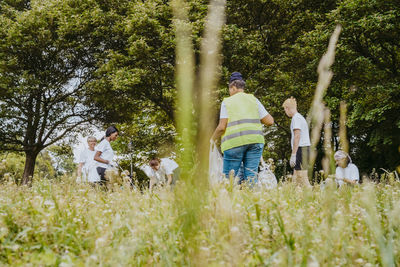 Team of environmentalists picking up plastics at park