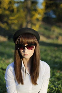 Portrait of woman wearing sunglasses standing outdoors