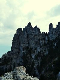 Low angle view of rock formation against sky