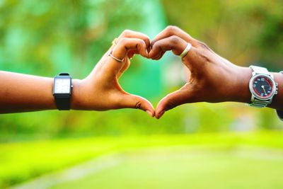 Close-up of hand holding hands against blurred background