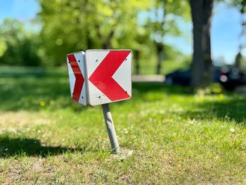 Close-up of road sign on field