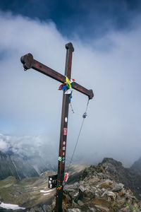 Crane on snowcapped mountain against sky