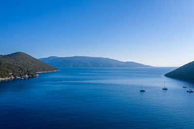 Scenic view of sea against clear blue sky