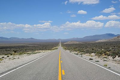 Empty desert road against sky