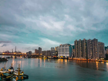 Illuminated buildings by city against sky