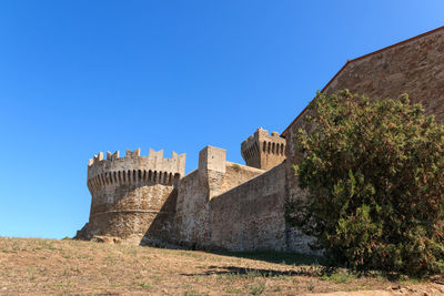 Low angle view of fort against blue sky