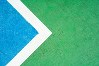 High angle view of arrow symbol on green grass