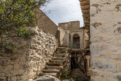 Low angle view of old staircase by building