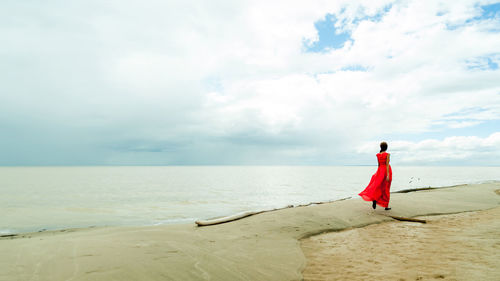 Rear view of woman standing on beach