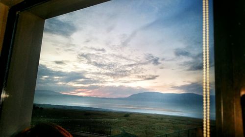 Scenic view of landscape seen through window