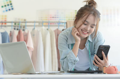 Young woman using mobile phone in cafe