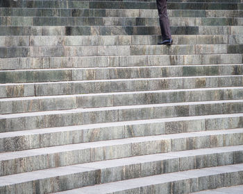 Low section of man moving up on steps