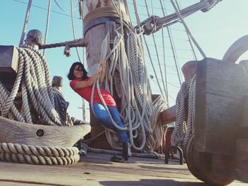 People on sailboat against sky