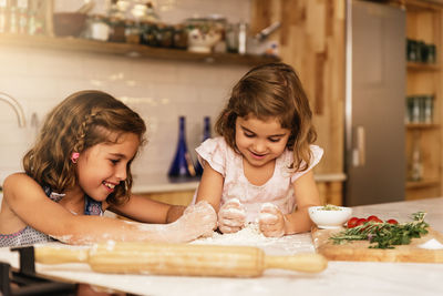 Portrait of happy mother and daughter at home