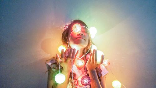 Low angle view of young woman against sky