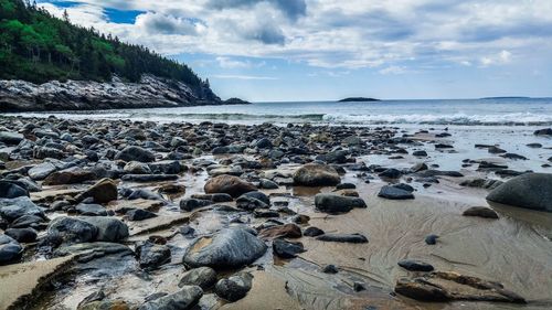 Rocks on beach against sky