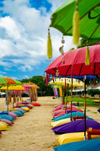 Multi colored umbrellas on beach against sky