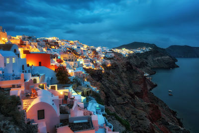 High angle view of townscape by sea against sky