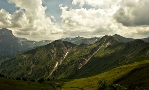 Scenic view of mountains against cloudy sky