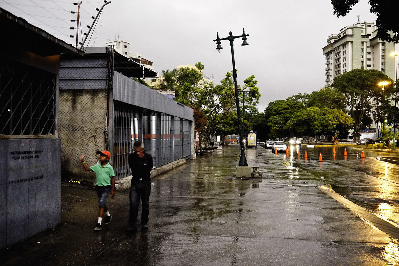 architecture, wet, rain, building exterior, built structure, street, city, building, men, water, walking, real people, full length, sky, nature, incidental people, rainy season, monsoon, outdoors