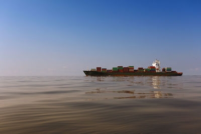 Ship sailing in sea against sky