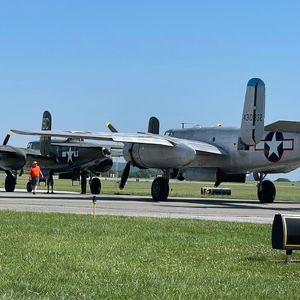 Airplane on airport runway against clear sky