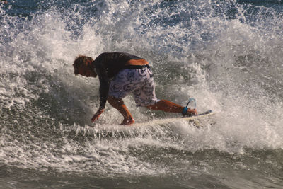 Full length of man surfing in sea