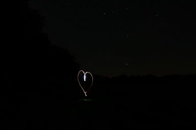 Low angle view of balloons against sky at night