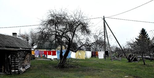 Houses on countryside landscape against clear sky