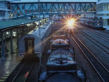 Trains on railroad station at dusk