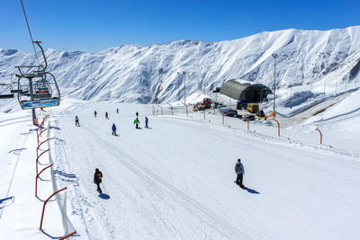 View from the cable car to the ski slope with snowboarders