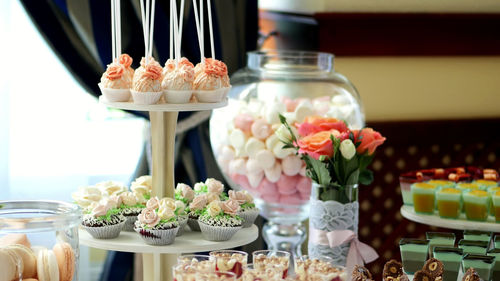 Close-up, a variety of delicious desserts, cakes with cream, strawberries, chocolate, under icing 