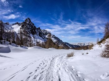 Scenic view of snow covered mountains against sky