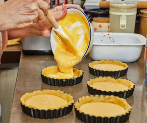 Cropped hand of person preparing food on table