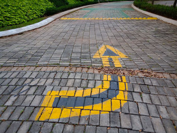 High angle view of arrow sign on road