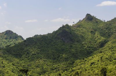 Low angle view of green mountains against sky