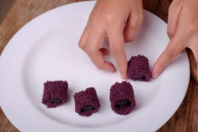 High angle view of hand holding ice cream in plate