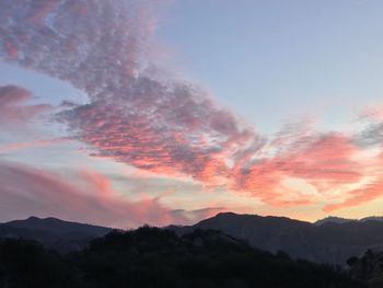 Low angle view of silhouette mountains against sky at sunset