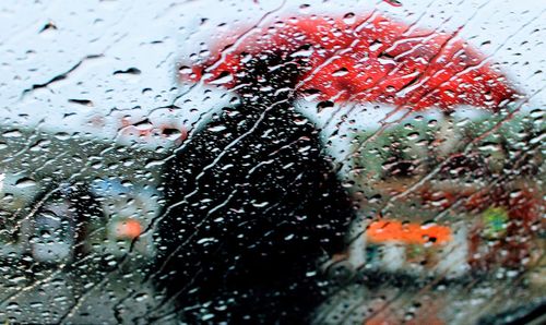 Man under a red umbrella.