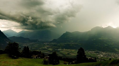 Scenic view of mountains against cloudy sky