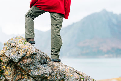 Low section of man standing on rock