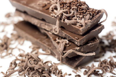 Close-up of stacked chocolate bars with shavings