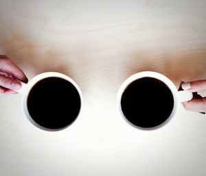 Close-up of hand holding coffee cup