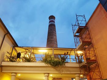 Low angle view of factory against sky